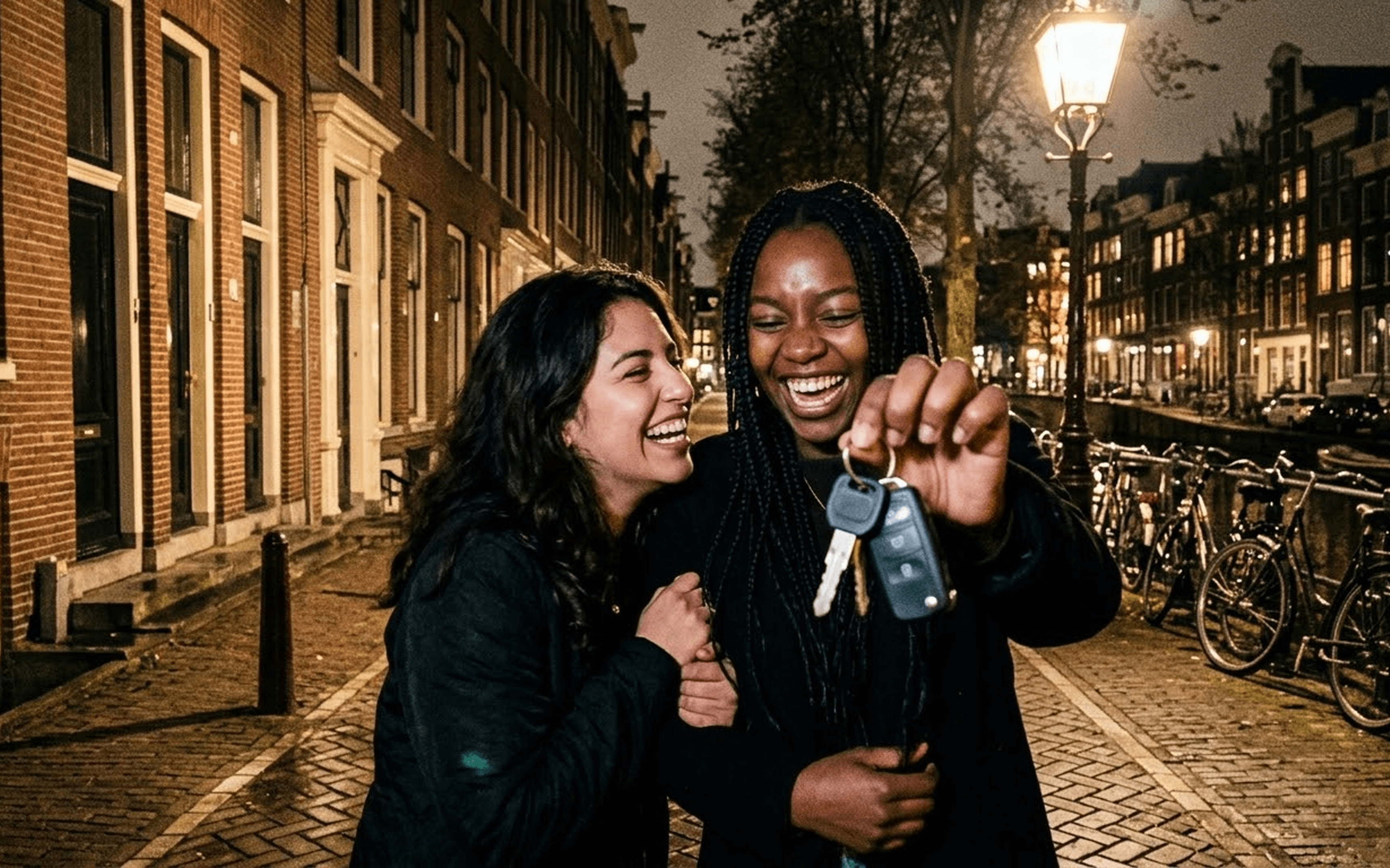 Two friends celebrating with keys on an Amsterdam canal